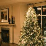 Christmas tree glowing with warm white lights in a living room