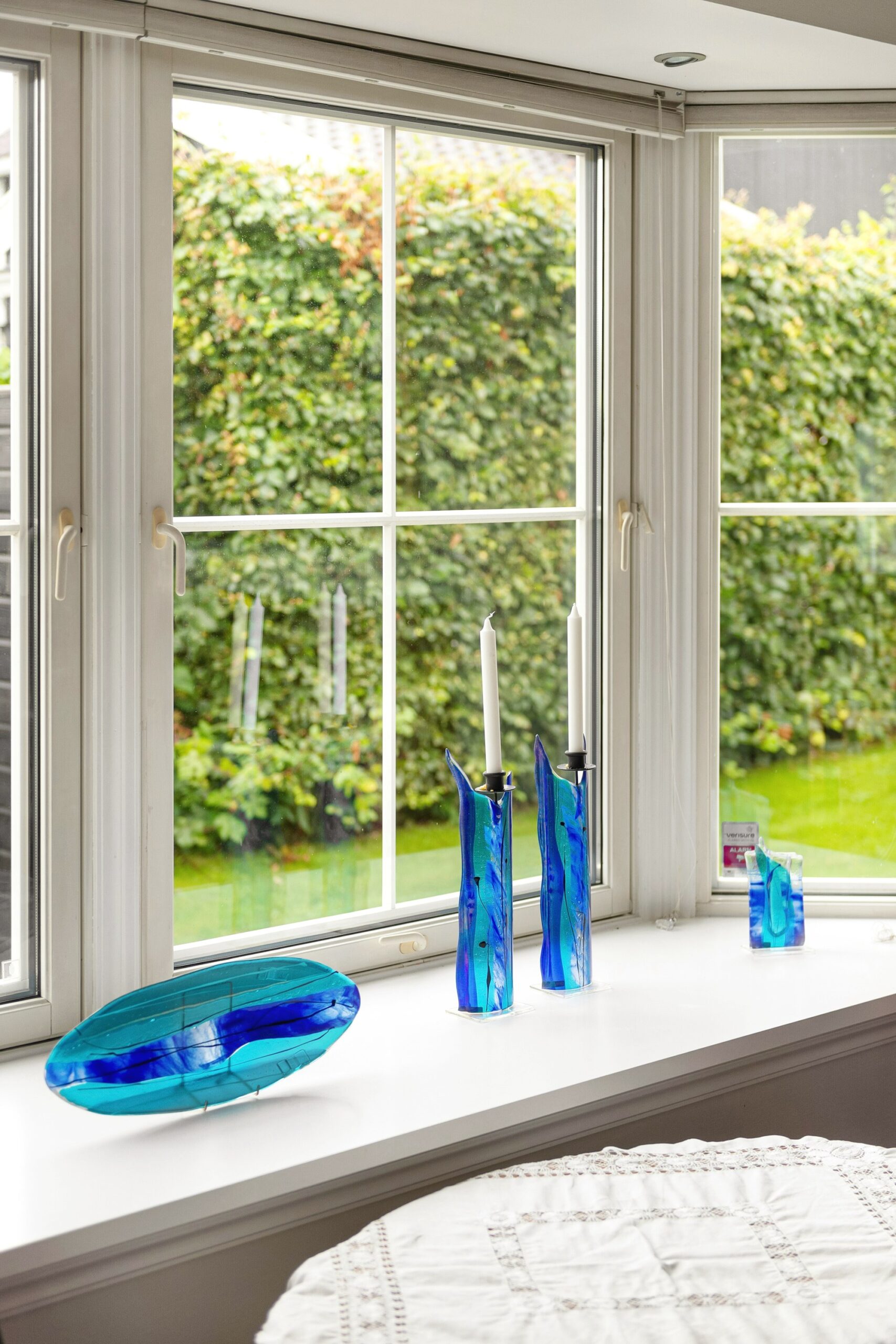 Blue glass bottles on a bright windowsill