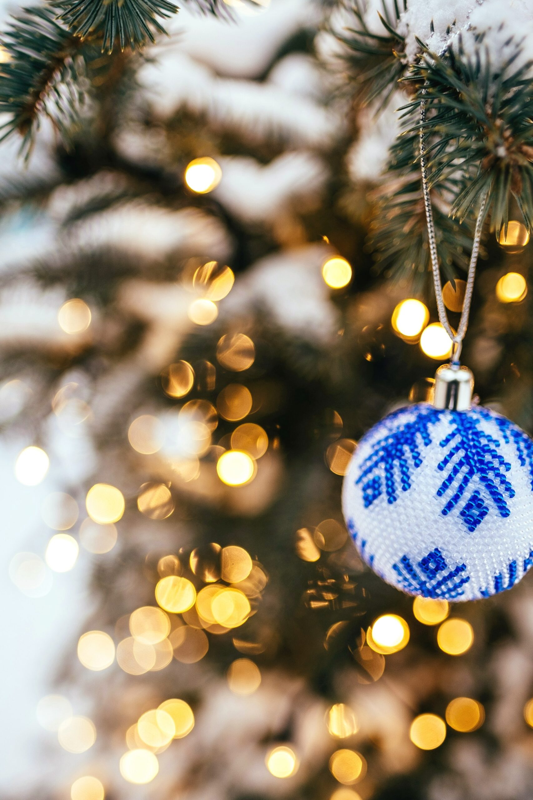 Blue and white patterned ornament on a lit tree