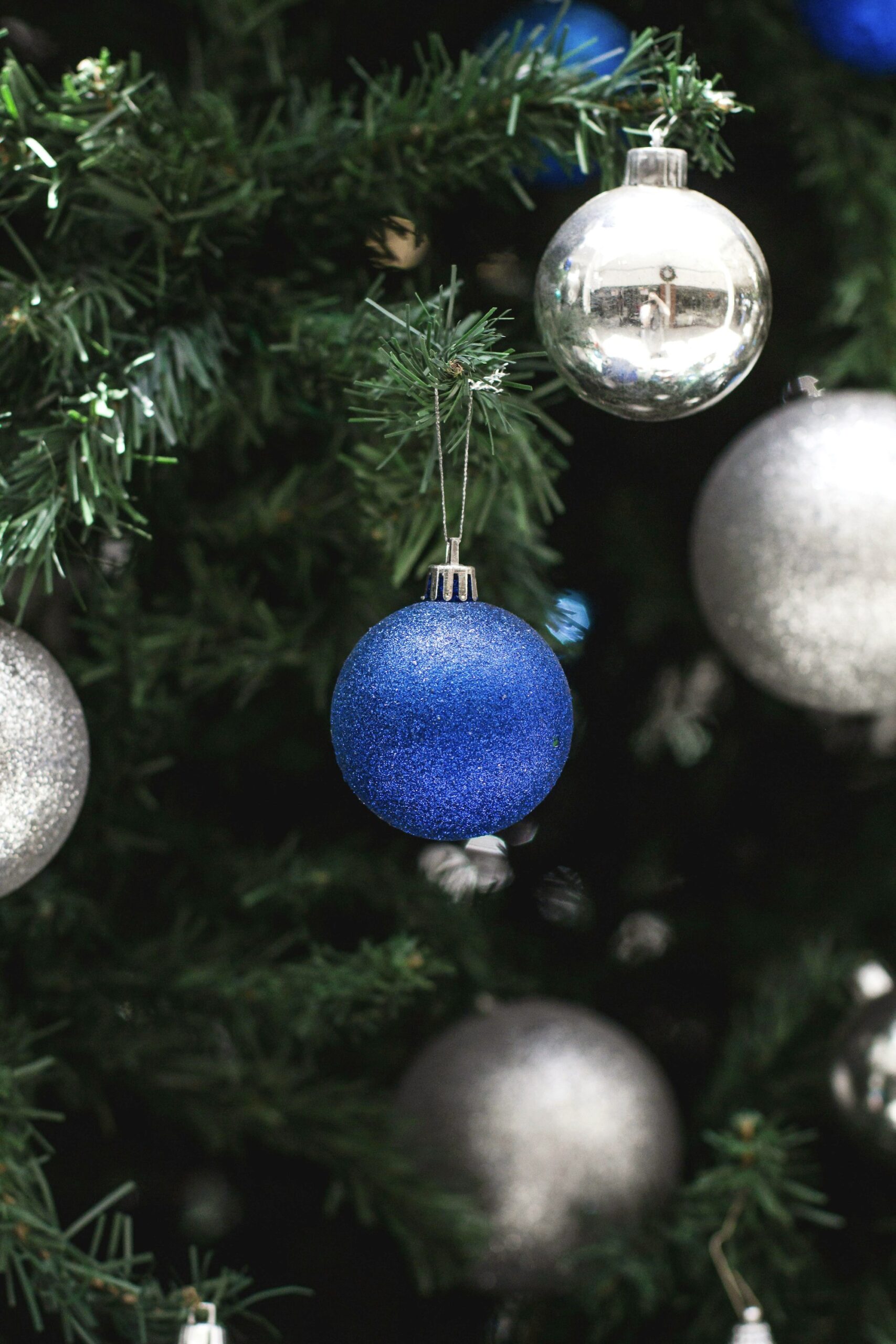 Blue and silver ornaments on a Christmas tree