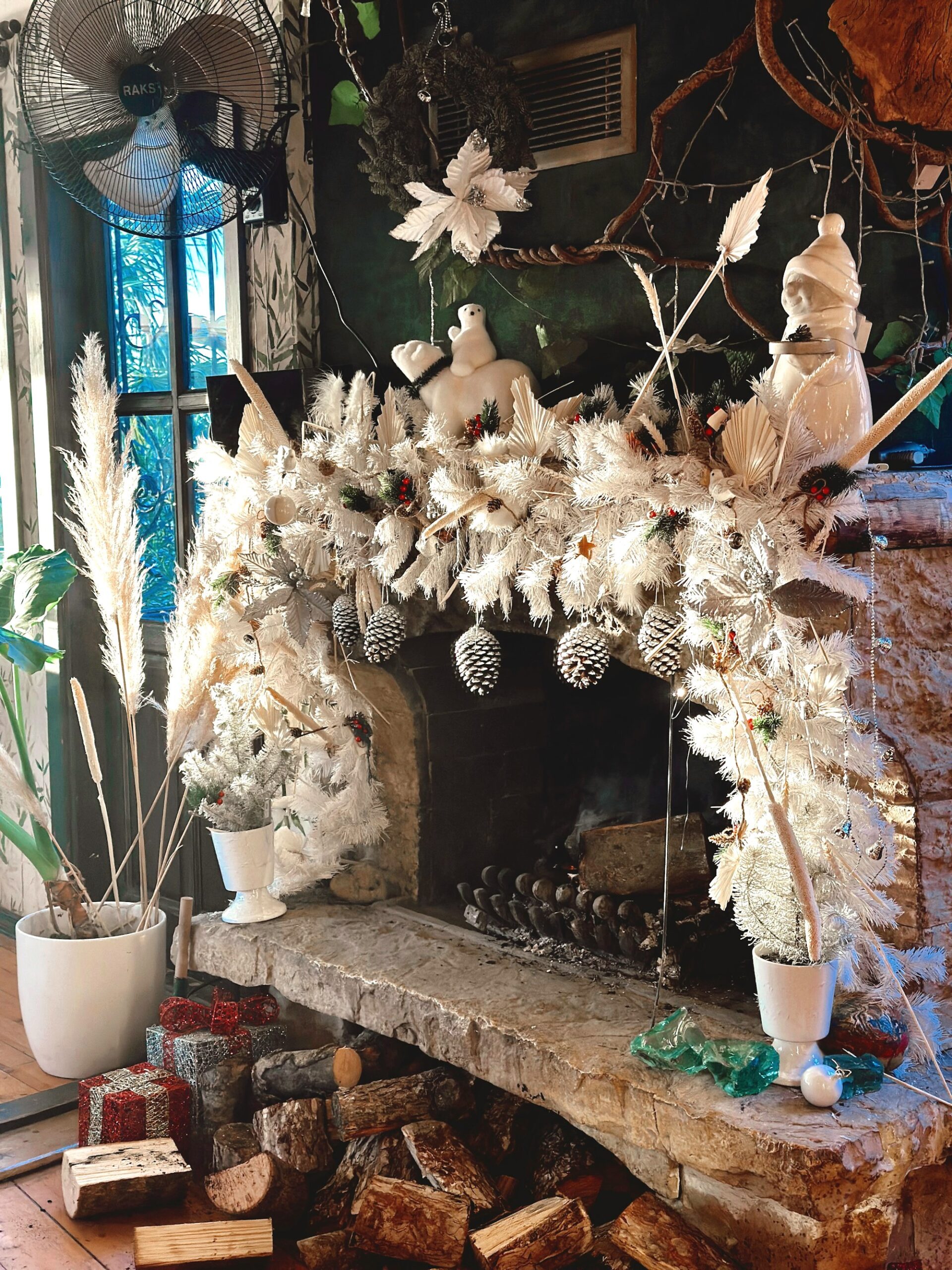 Fireplace with a white frosted garland and pinecones