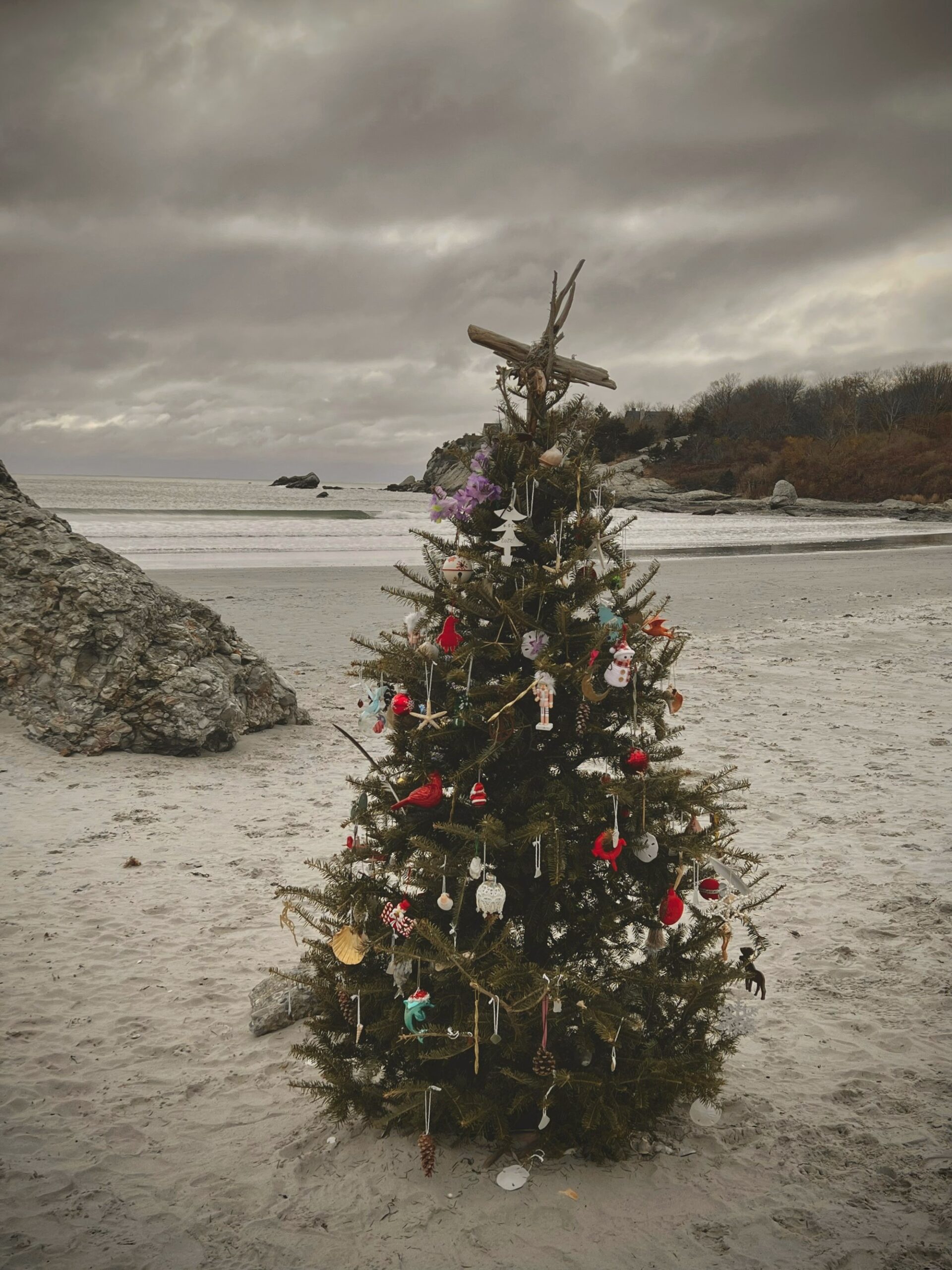 Small decorated Christmas tree on a sandy beach