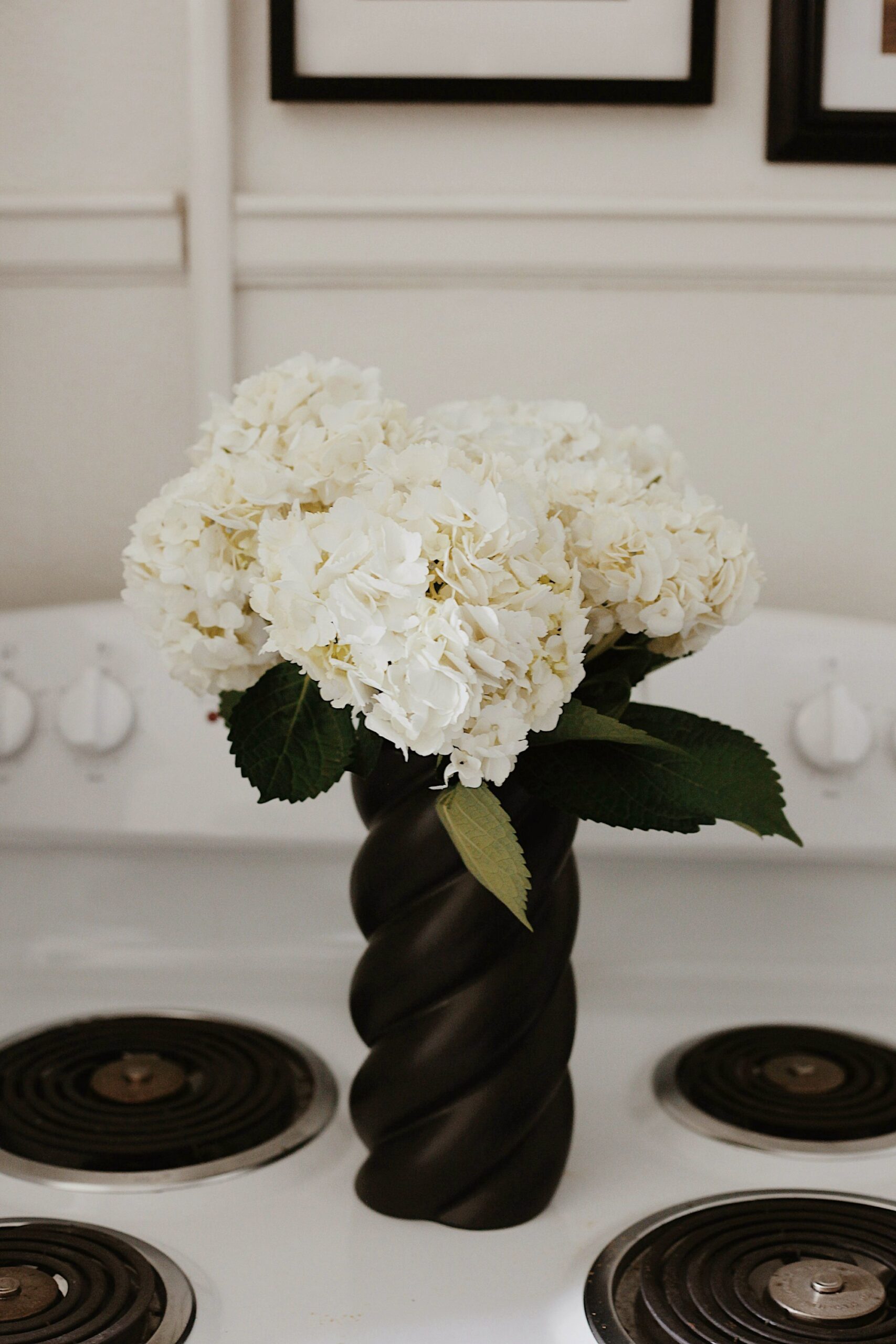 White hydrangeas in a rope-wrapped vase