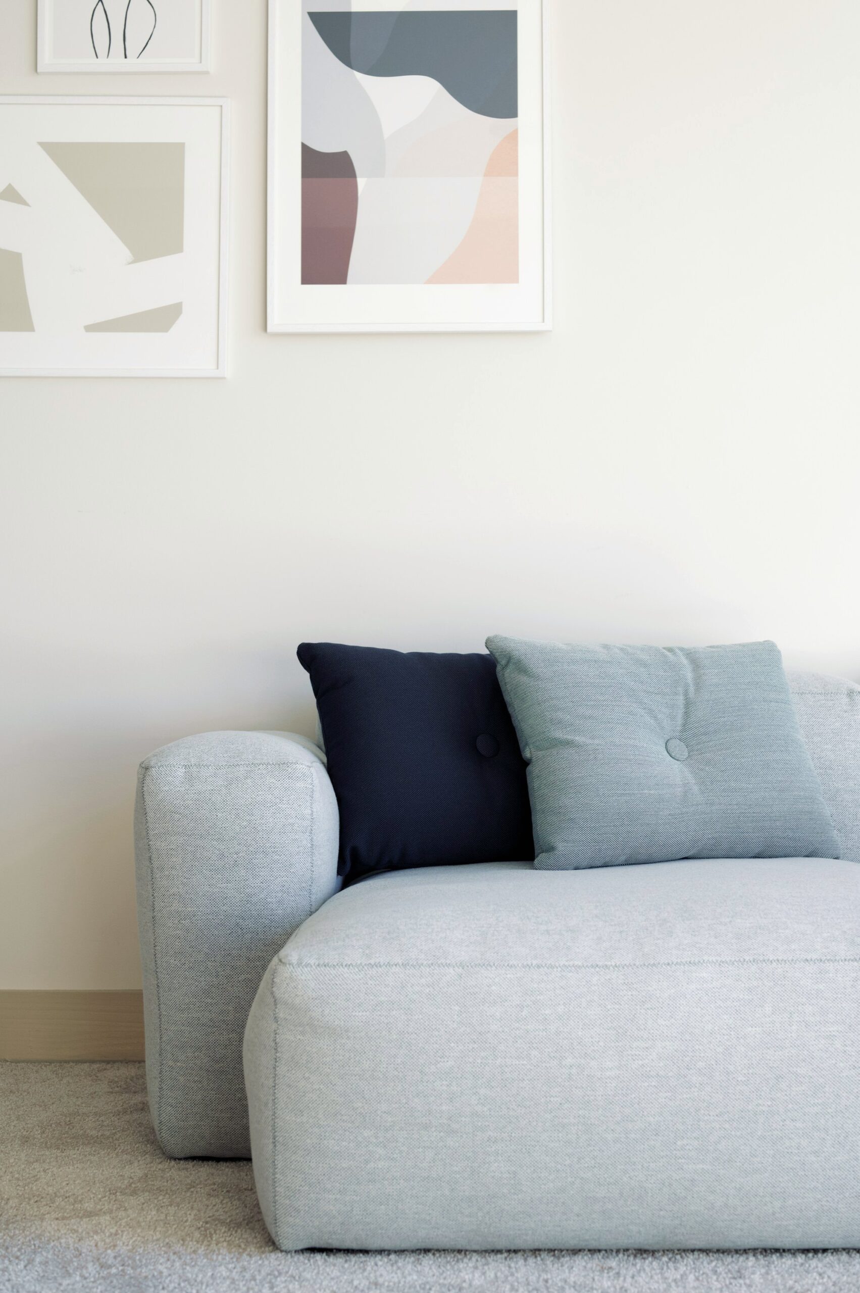 White linen sofa with a navy accent pillow
