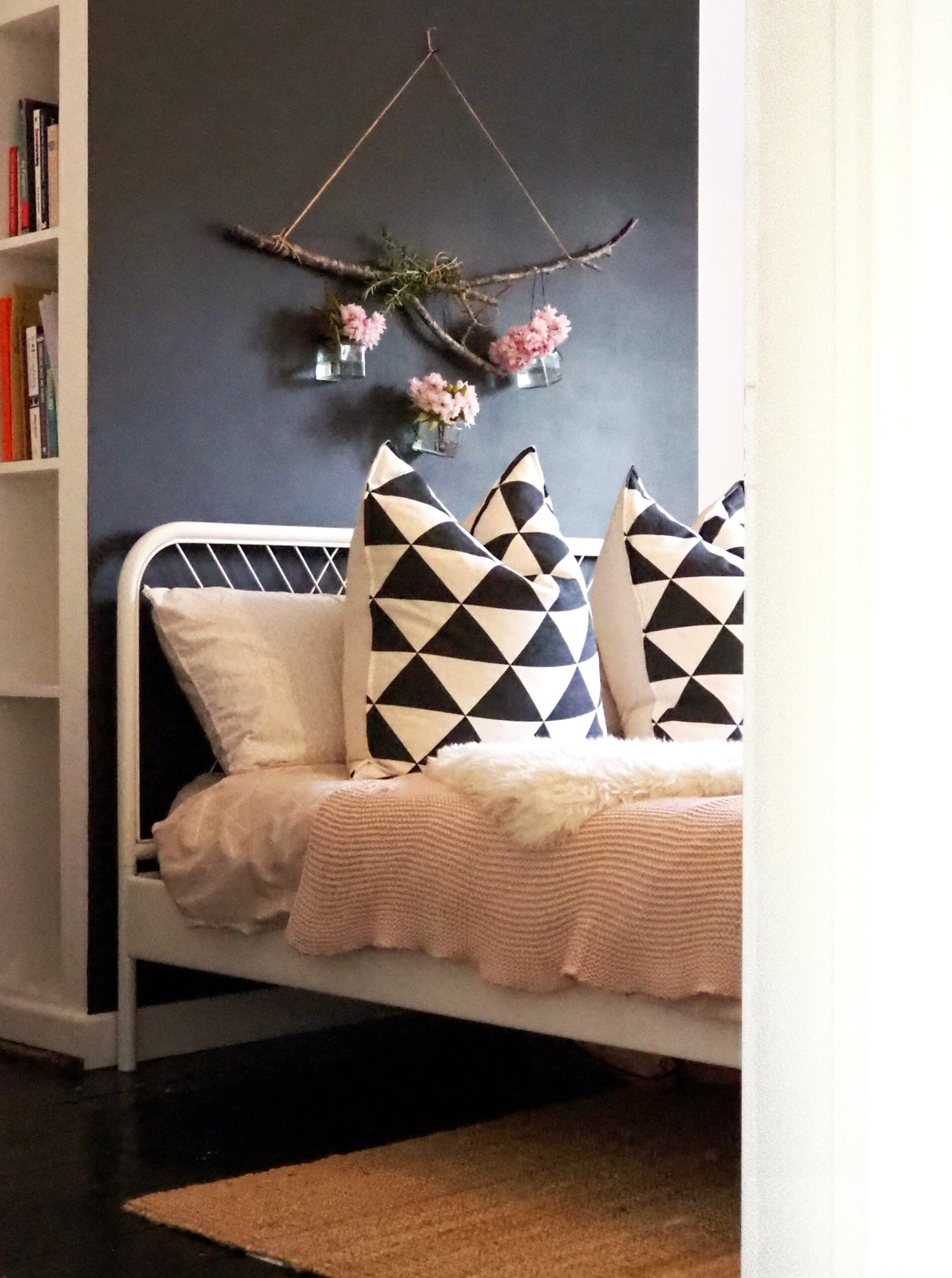 Navy and white patterned pillows on a cozy bed